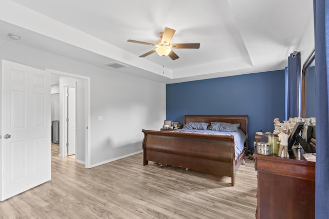 1917 Willoughby Rd, Clever, MO 65631 - bedroom featuring a tray ceiling, wood finished floors, and ceiling fan
