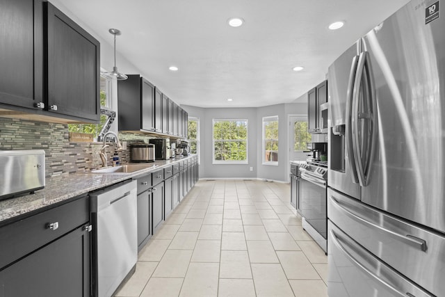 1917 Willoughby Rd, Clever, MO 65631 - kitchen featuring stainless steel appliances, recessed lighting, tasteful backsplash, light tile patterned flooring, and light stone countertops