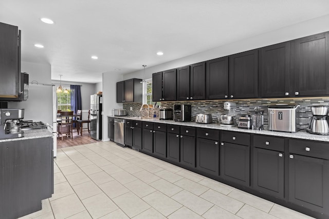 1917 Willoughby Rd, Clever, MO 65631 - kitchen with stainless steel appliances, backsplash, recessed lighting, light stone counters, and light tile patterned flooring