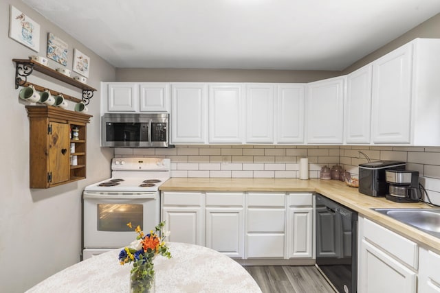 2116 N Main Ave, Springfield, MO 65803 - kitchen with stainless steel microwave, white electric range, black dishwasher, and light countertops