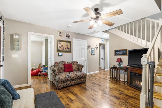 2116 N Main Ave, Springfield, MO 65803 - living room featuring ceiling fan, stairway, wood finished floors, and a glass covered fireplace