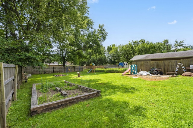 2116 N Main Ave, Springfield, MO 65803 - fenced backyard featuring a playground and a vegetable garden