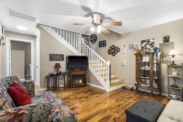 2116 N Main Ave, Springfield, MO 65803 - living room with stairs, a ceiling fan, and wood finished floors