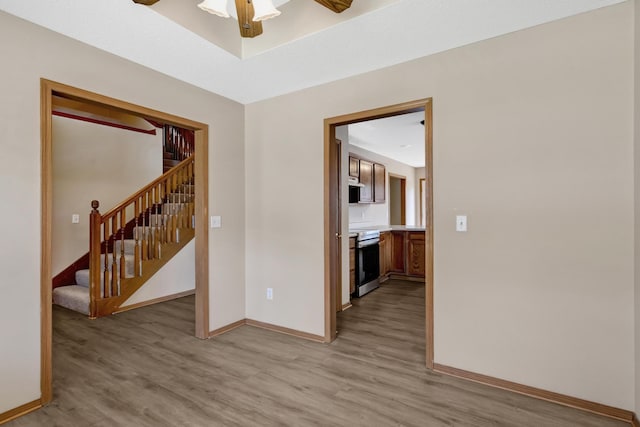 5590 S Aaron Ave, Springfield, MO 65810 - unfurnished room featuring light wood-style floors, stairway, and a ceiling fan