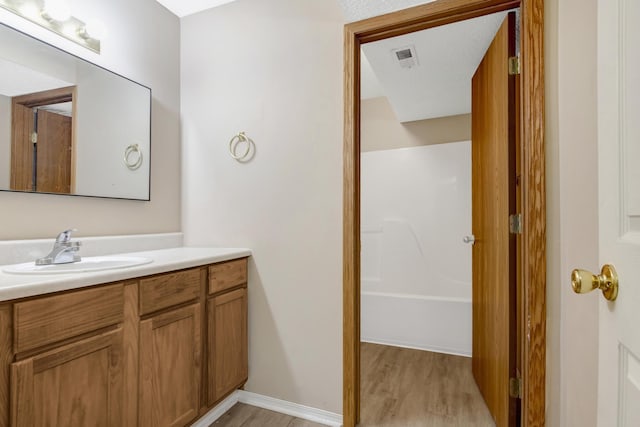 5590 S Aaron Ave, Springfield, MO 65810 - full bath with vanity, wood finished floors, and shower / washtub combination