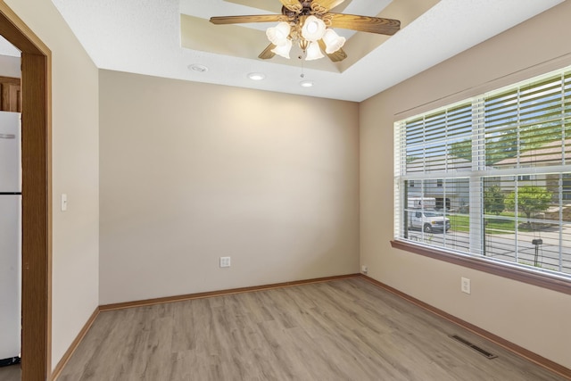 5590 S Aaron Ave, Springfield, MO 65810 - unfurnished room featuring light wood finished floors, a ceiling fan, recessed lighting, and a tray ceiling