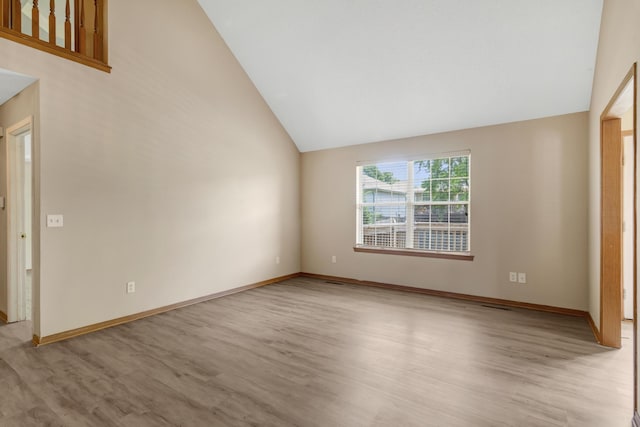5590 S Aaron Ave, Springfield, MO 65810 - spare room featuring light wood-type flooring and high vaulted ceiling