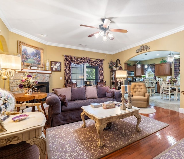 110 Stillwood Dr, Branson, MO 65616 - living room featuring a ceiling fan, healthy amount of natural light, a stone fireplace, and ornamental molding
