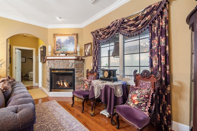 110 Stillwood Dr, Branson, MO 65616 - living area with arched walkways, ornamental molding, a stone fireplace, and wood finished floors