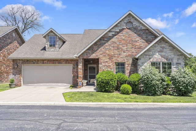 110 Stillwood Dr, Branson, MO 65616 - view of front of property featuring an attached garage, concrete driveway, roof with shingles, and brick siding