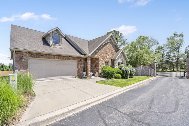 110 Stillwood Dr, Branson, MO 65616 - view of front of house featuring driveway, a gate, an attached garage, and brick siding