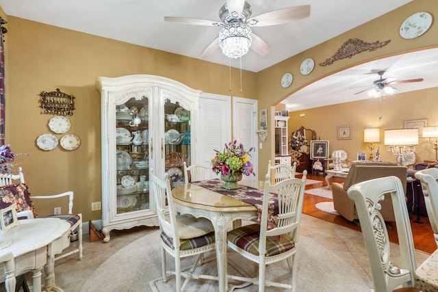 110 Stillwood Dr, Branson, MO 65616 - dining room featuring ceiling fan, arched walkways, and light tile patterned flooring