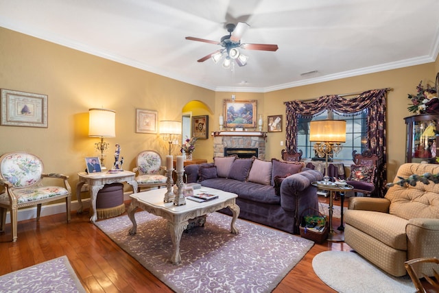 110 Stillwood Dr, Branson, MO 65616 - living room featuring ceiling fan, hardwood / wood-style flooring, ornamental molding, a stone fireplace, and arched walkways