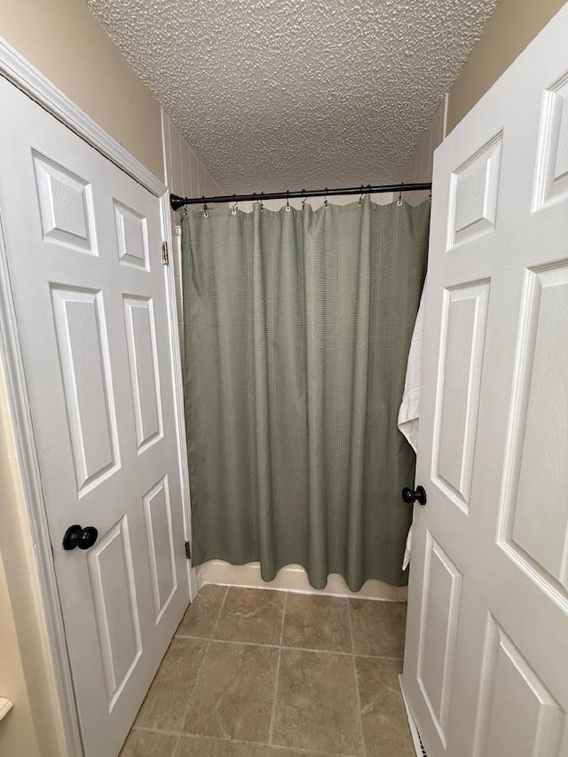 16051 Mo 142, Thayer, MO 65791 - bathroom featuring a textured ceiling, tile patterned floors, and a shower with shower curtain