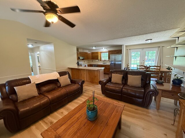16051 Mo 142, Thayer, MO 65791 - living area featuring light wood-type flooring, a textured ceiling, french doors, ceiling fan, and vaulted ceiling