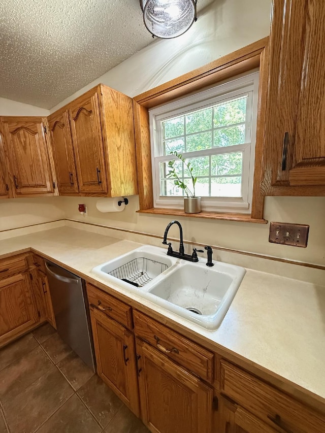 16051 Mo 142, Thayer, MO 65791 - kitchen featuring stainless steel dishwasher, brown cabinets, light countertops, and dark tile patterned flooring