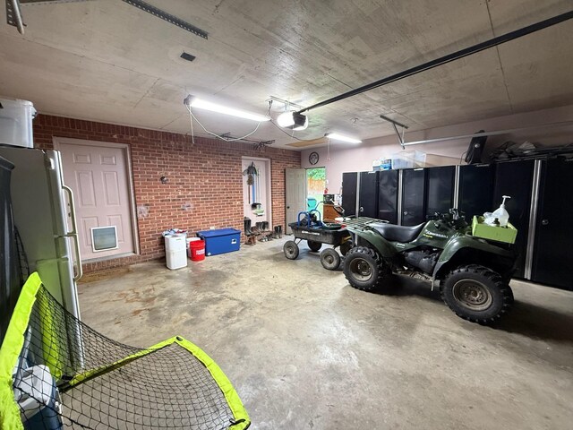 16051 Mo 142, Thayer, MO 65791 - garage featuring a garage door opener and freestanding refrigerator