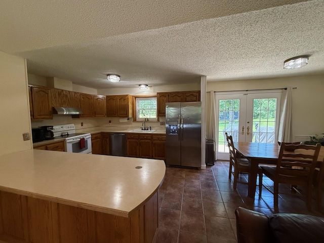 16051 Mo 142, Thayer, MO 65791 - kitchen featuring appliances with stainless steel finishes, exhaust hood, french doors, light countertops, and plenty of natural light