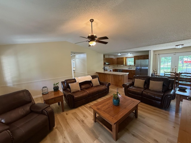 16051 Mo 142, Thayer, MO 65791 - living area featuring light wood-style floors, ceiling fan, a textured ceiling, and vaulted ceiling