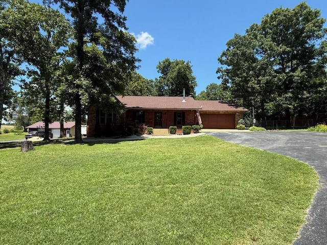 16051 Mo 142, Thayer, MO 65791 - ranch-style home featuring asphalt driveway, an attached garage, and a front lawn