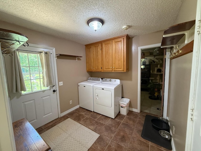 16051 Mo 142, Thayer, MO 65791 - washroom with washing machine and dryer, dark tile patterned flooring, a textured ceiling, and cabinet space