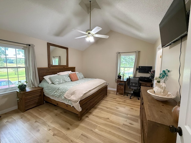 16051 Mo 142, Thayer, MO 65791 - bedroom with light wood-type flooring, vaulted ceiling, multiple windows, a desk, and a ceiling fan