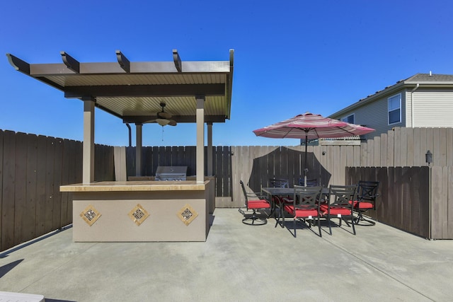 440 Spring Meadow Pkwy, Branson, MO 65616 - fenced backyard with an outdoor kitchen, ceiling fan, a patio area, and outdoor dining area