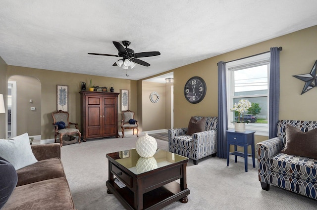 1841 E Dale St, Springfield, MO 65803 - living area with arched walkways, a ceiling fan, light colored carpet, and a textured ceiling