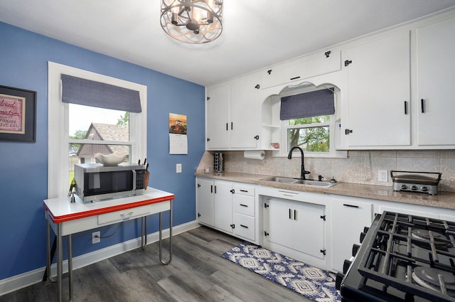 1841 E Dale St, Springfield, MO 65803 - kitchen featuring stainless steel microwave, black gas range, light countertops, and tasteful backsplash