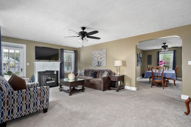 1841 E Dale St, Springfield, MO 65803 - carpeted living room with ceiling fan, arched walkways, and a textured ceiling