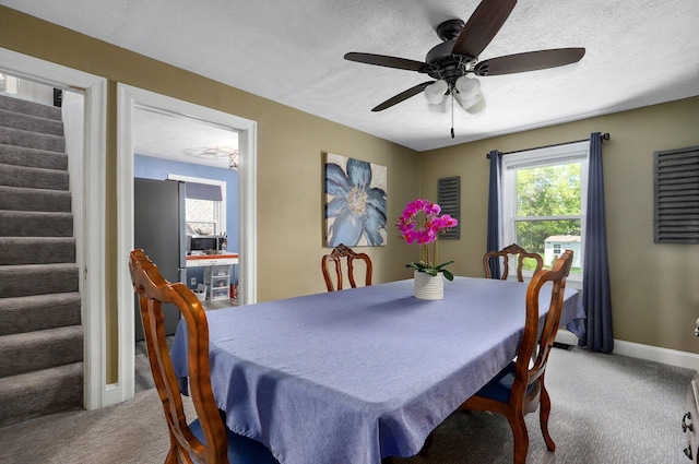 1841 E Dale St, Springfield, MO 65803 - carpeted dining space with stairs, a textured ceiling, and ceiling fan