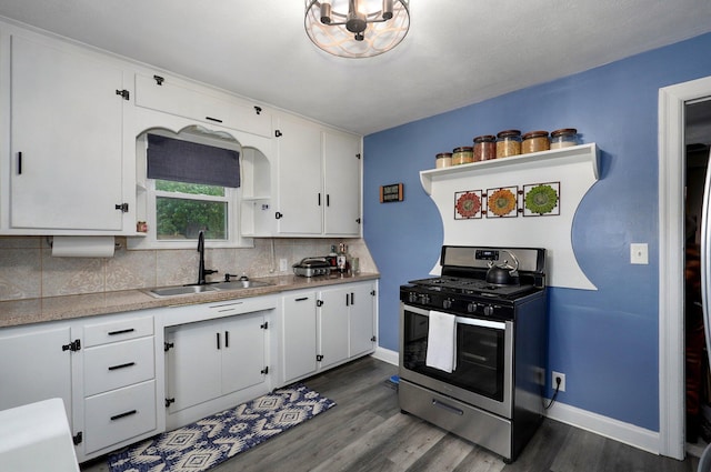 1841 E Dale St, Springfield, MO 65803 - kitchen featuring stainless steel range with gas stovetop, decorative backsplash, dark wood-style flooring, white cabinetry, and light countertops