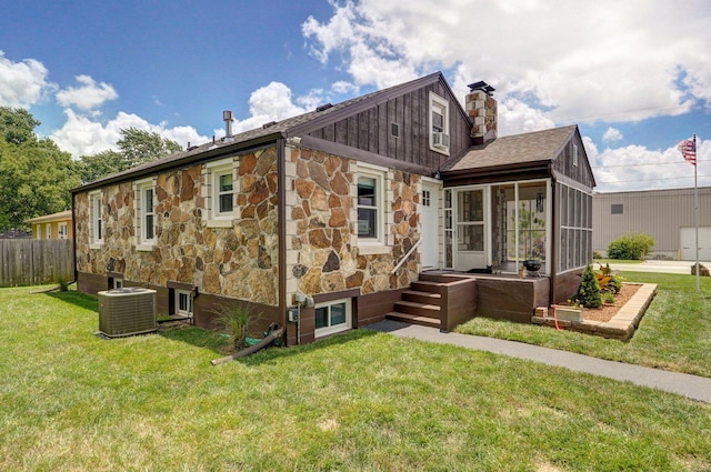 1841 E Dale St, Springfield, MO 65803 - rear view of house with a sunroom, stone siding, a chimney, and roof with shingles