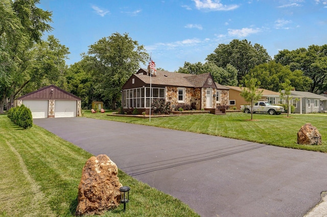 1841 E Dale St, Springfield, MO 65803 - single story home featuring stone siding, a garage, an outdoor structure, a front yard, and a sunroom