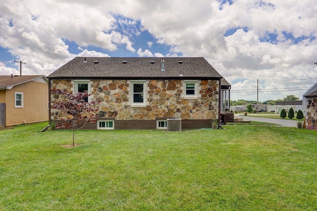 1841 E Dale St, Springfield, MO 65803 - back of house with stone siding, a lawn, and a shingled roof