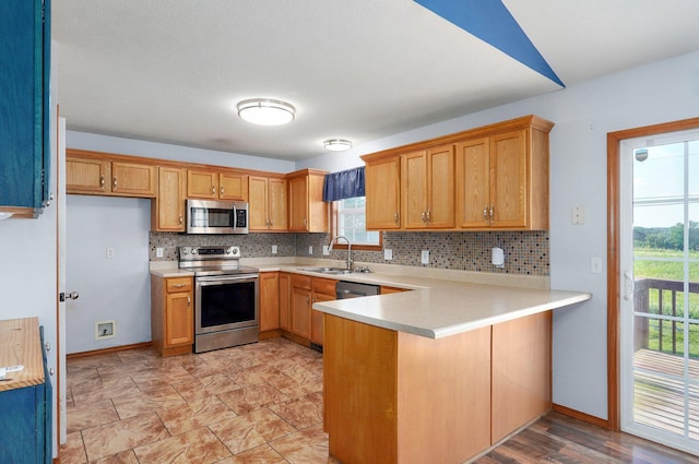 1603 W Robin St, Ozark, MO 65721 - kitchen with appliances with stainless steel finishes, tasteful backsplash, a peninsula, and light countertops