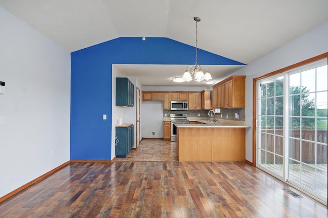 1603 W Robin St, Ozark, MO 65721 - kitchen featuring appliances with stainless steel finishes, a chandelier, hardwood / wood-style flooring, vaulted ceiling, and a peninsula