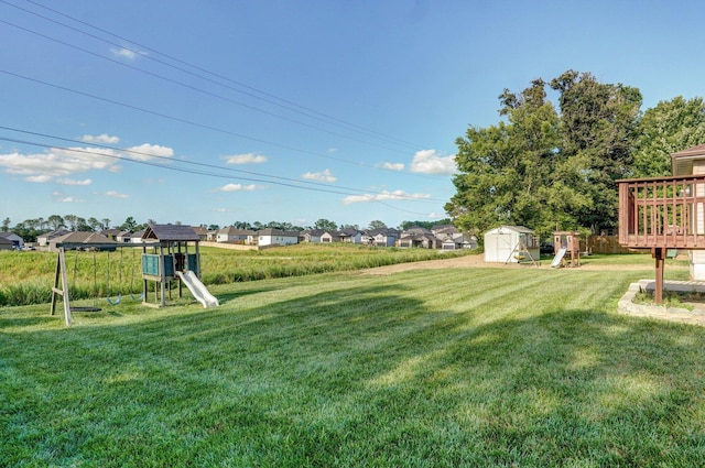 1603 W Robin St, Ozark, MO 65721 - view of green lawn featuring a playground, a storage unit, and a residential view