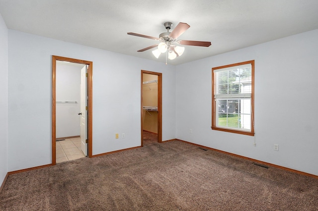 1603 W Robin St, Ozark, MO 65721 - unfurnished bedroom featuring light carpet, a spacious closet, a closet, connected bathroom, and ceiling fan