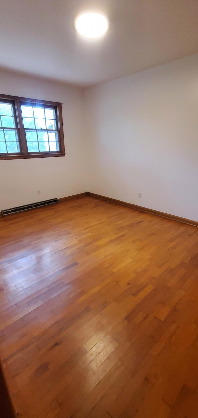 918 E Mcgee St, Springfield, MO 65807 - spare room with a baseboard heating unit and wood finished floors
