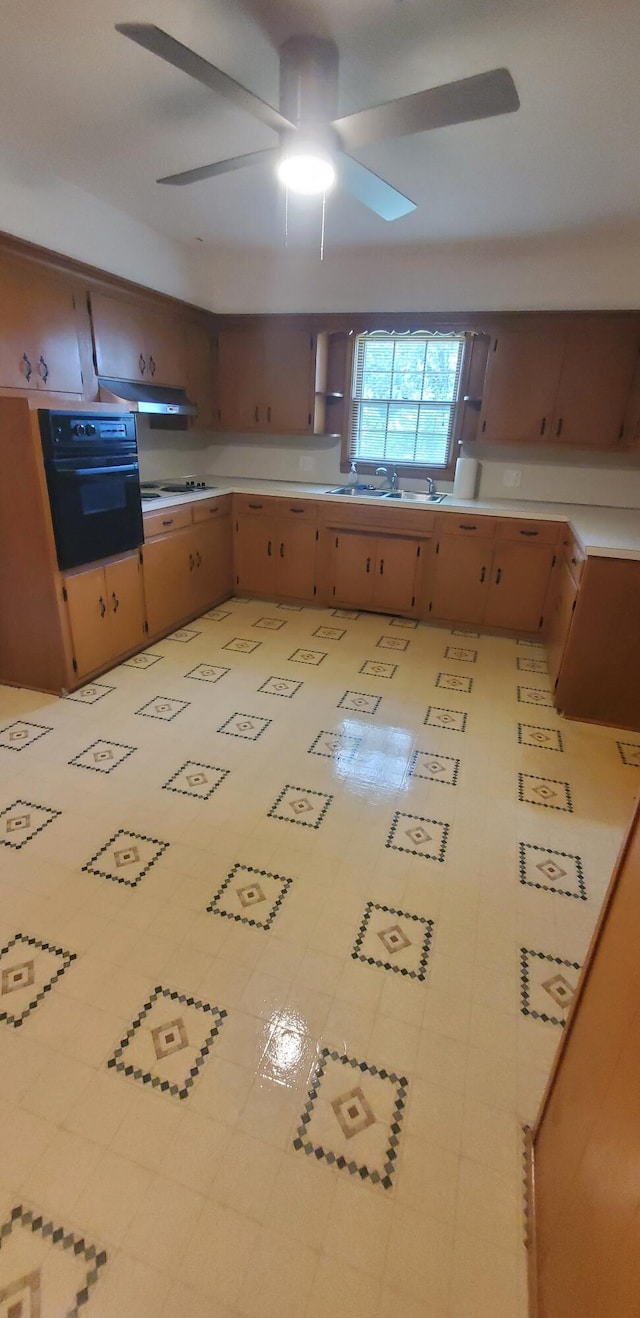 918 E Mcgee St, Springfield, MO 65807 - kitchen with oven, ceiling fan, under cabinet range hood, and light countertops