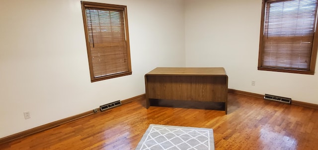 918 E Mcgee St, Springfield, MO 65807 - spare room featuring baseboards and wood finished floors