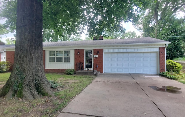 918 E Mcgee St, Springfield, MO 65807 - ranch-style house featuring concrete driveway, brick siding, an attached garage, a chimney, and a shingled roof