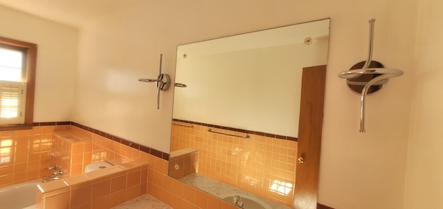 918 E Mcgee St, Springfield, MO 65807 - full bathroom featuring a bath, tile walls, and a wainscoted wall