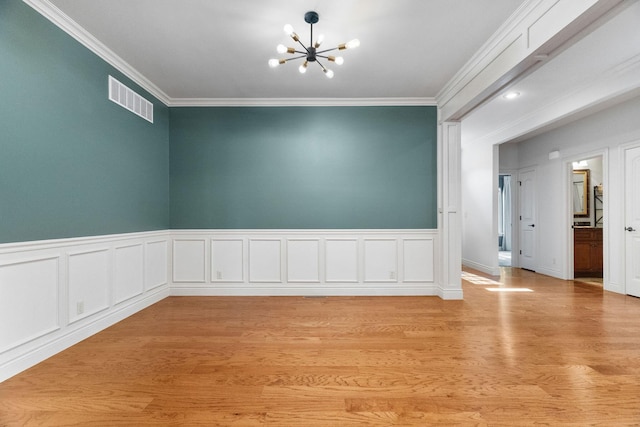 253 Cedar Glade Dr, Branson West, MO 65737 - empty room with a chandelier, crown molding, light wood finished floors, and wainscoting
