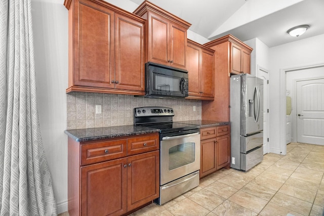 253 Cedar Glade Dr, Branson West, MO 65737 - kitchen featuring stainless steel appliances, backsplash, lofted ceiling, dark stone countertops, and brown cabinetry