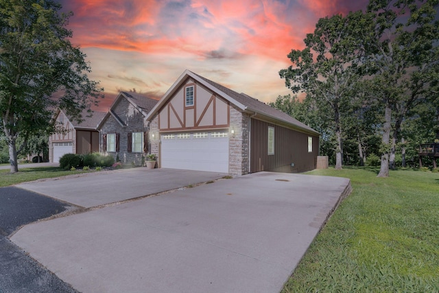 253 Cedar Glade Dr, Branson West, MO 65737 - english style home featuring concrete driveway, stone siding, a lawn, and an attached garage