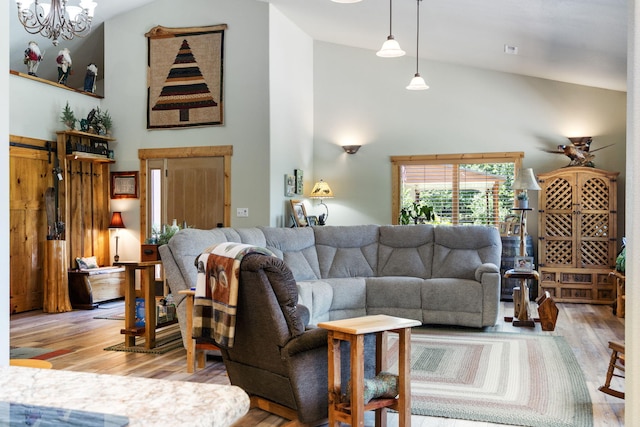 26474 Kings River Rd, Shell Knob, MO 65747 - living area with wood finished floors, a chandelier, and high vaulted ceiling