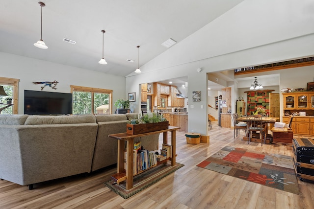 26474 Kings River Rd, Shell Knob, MO 65747 - living area featuring light wood finished floors, plenty of natural light, high vaulted ceiling, and a chandelier