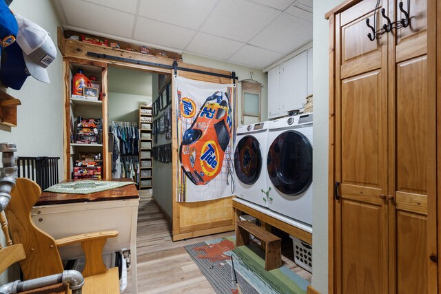 26474 Kings River Rd, Shell Knob, MO 65747 - washroom with washer and clothes dryer, light wood-type flooring, and cabinet space
